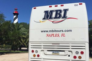 MBI Charter Bus Transportation parked in front of lighthouse in Florida - MBI Charters